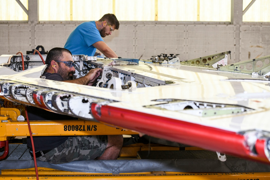 250327-N-DG679-1058
JACKSONVILLE, Fla. (March 27, 2025) Kristopher Williams (left) and Jeffrey Zumwalde, sheet metal mechanics at Fleet Readiness Center Southeast, perform service life extension program upgrades on a T-45 Goshawk wing. The T-45 jet aircraft is used for intermediate and advanced portions of the Navy/Marine Corps pilot training program. (U.S. Navy photo by Toiete Jackson)