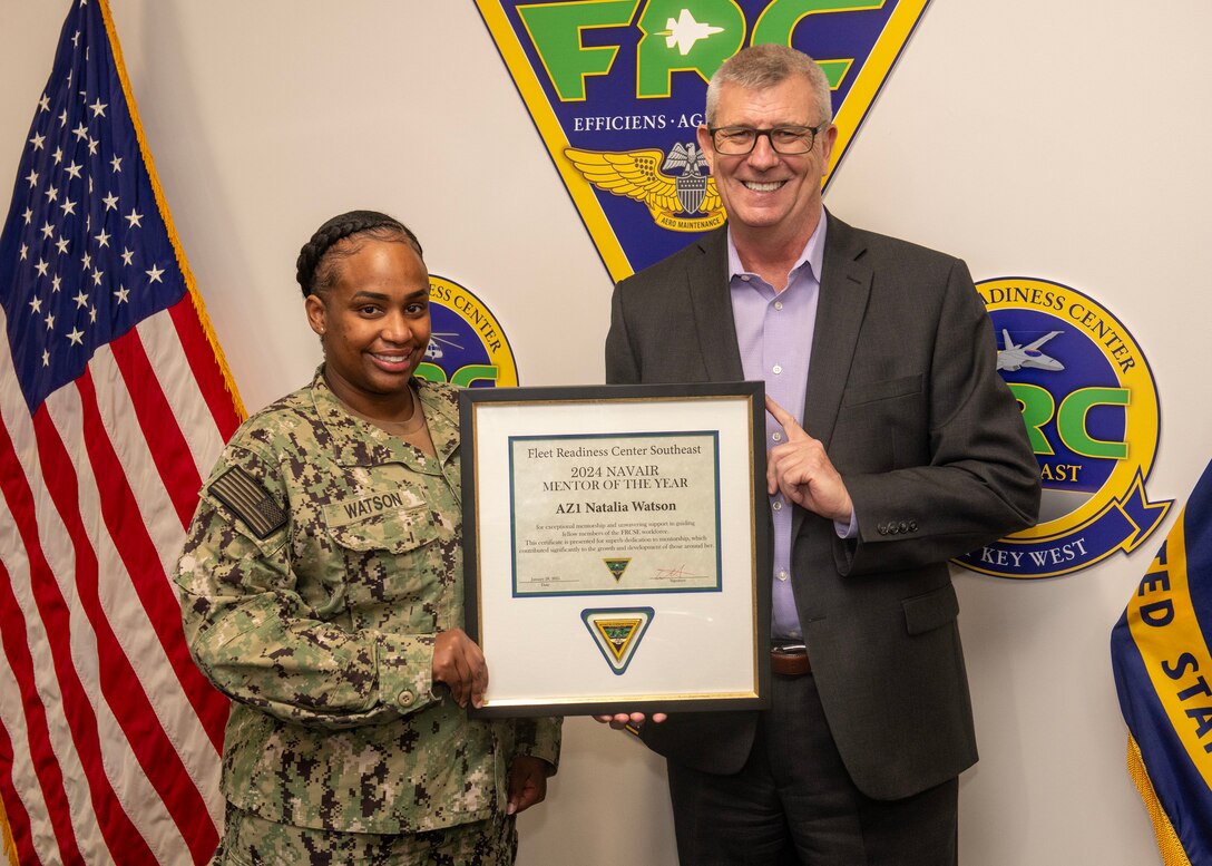 250128-N-BK290-1006
JACKSONVILLE, Fla. – Tim Pfannenstein, Fleet Readiness Center Southeast’s (FRCSE) executive director, presents Aviation Maintenance Administrationman 1st Class Natalia Watson with the Naval Air Systems Command’s Mentor of the Year Award for FRCSE. She was selected for this award for providing exceptional mentorship to the workforce, helping increase productivity and improve morale.