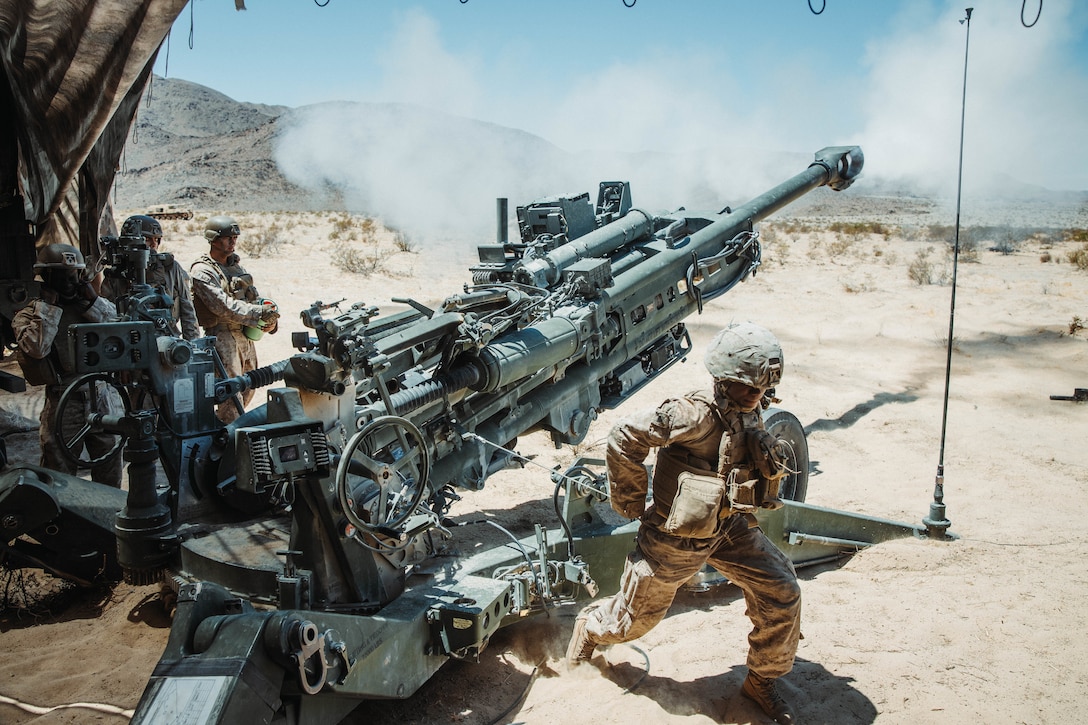 U.S. Marines temporarily assigned to 2nd Battalion, 10th Marine Regiment, 2nd Marine Division, fire a M777 Howitzer during Service Level Training Exercise 4-25 at Marine Corps Air Ground Combat Center Twentynine Palms, California, Aug. 5, 2025. SLTE is designed to be a challenging, realistic training environment that produces combat-ready forces capable of operating as an integrated Marine Air Ground Task Force. (U.S. Marine Corps photo by Lance Cpl. Gracelyn Hanson)