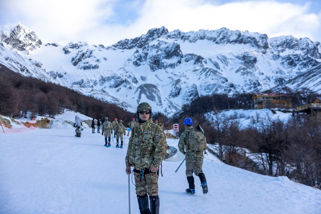 Midshipman of Infantry Marines. (2nd Lt.) Isaias Diaz, a member of the Battalion Infantria de Marine no. 5, hikes up a mountain during a cold weather exercise with U.S. Marines from the Mountain Warfare Training Center and  8th Engineer Support Battalion, 2nd Marine Logistics Group, in Ushuaia, Argentina, Aug. 12, 2025. This training creates opportunities for continued combined exercises with Argentine forces which aims to build upon the skills learned in these knowledge exchanges. (U.S. Marine Corps photo by Lance Cpl. Payton Goodrich)