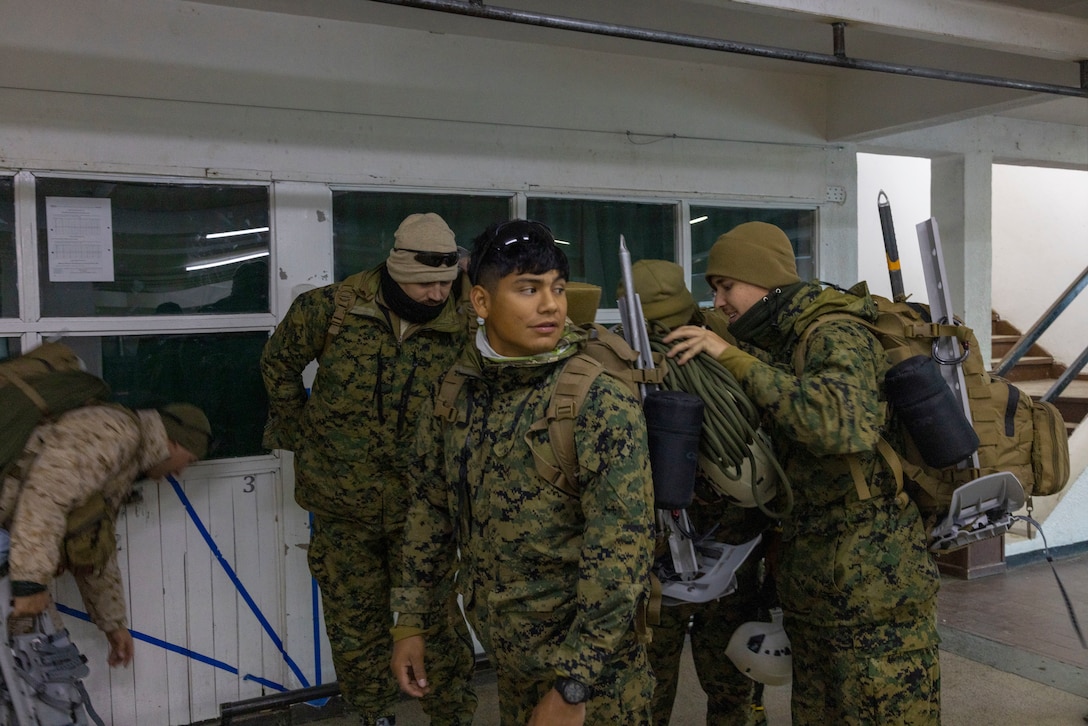 U.S. Marines with 8th Engineer Support Battalion, 2nd Marine Logistics Group, conduct gear checks before conducting a movement to a training area in Ushuaia, Argentina, Aug. 12, 2025. This training creates opportunities for continued combined exercises with Argentine forces which aim to build upon the skills learned in these knowledge exchanges. (U.S. Marine Corps photo by Lance Cpl. Payton Goodrich)