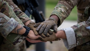 Emergency service team members assigned to the 6th Security Forces Squadron come together prior to a breaching demonstration at MacDill Air Force Base, Florida, Nov. 6, 2024. (U.S. Air Force photo by Senior Airman Zachary Foster)