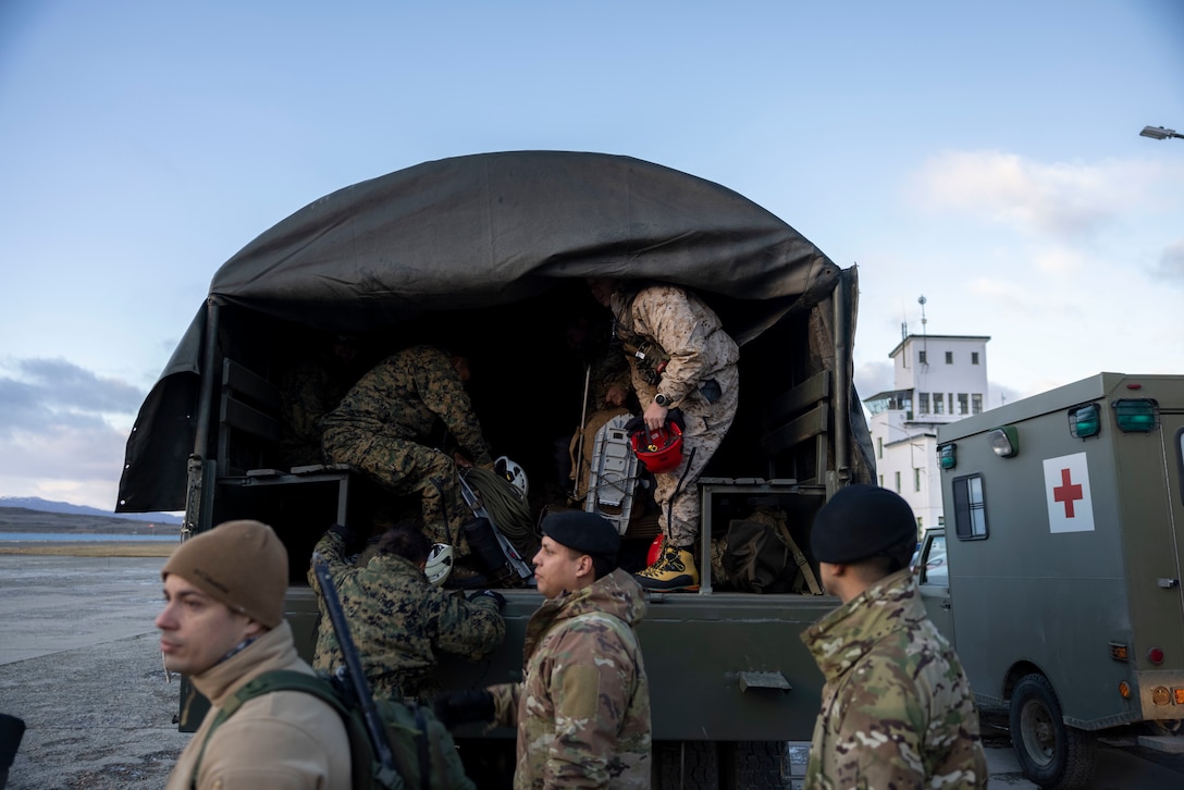 U.S. Marines with the Mountain Warfare Training Center and 8th Engineer Support Battalion, 2nd Marine Logistics Group and Argentine Marines, load into tactical vehicles to move to a training area in Ushuaia, Argentina, Aug. 12, 2025. This training creates opportunities for continued combined exercises with Argentine forces which aim to build upon the skills learned in these knowledge exchanges. (U.S. Marine Corps photo by Lance Cpl. Payton Goodrich)