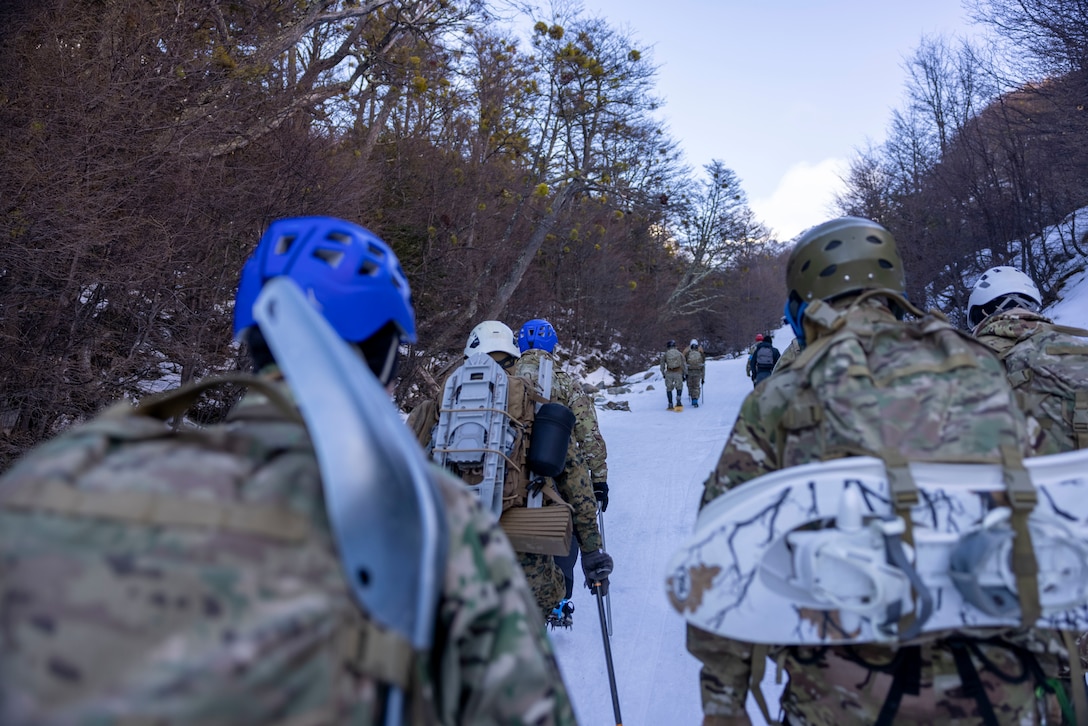 U.S. Marines with the Mountain Warfare Training Center and  8th Engineer Support Battalion, 2nd Marine Logistics Group and Argentine Marines, hike up a mountain during a cold weather exercise in Ushuaia, Argentina, Aug. 12, 2025. This training creates opportunities for continued combined exercises with Argentine forces which aim to build upon the skills learned in these knowledge exchanges. (U.S. Marine Corps photo by Lance Cpl. Payton Goodrich)