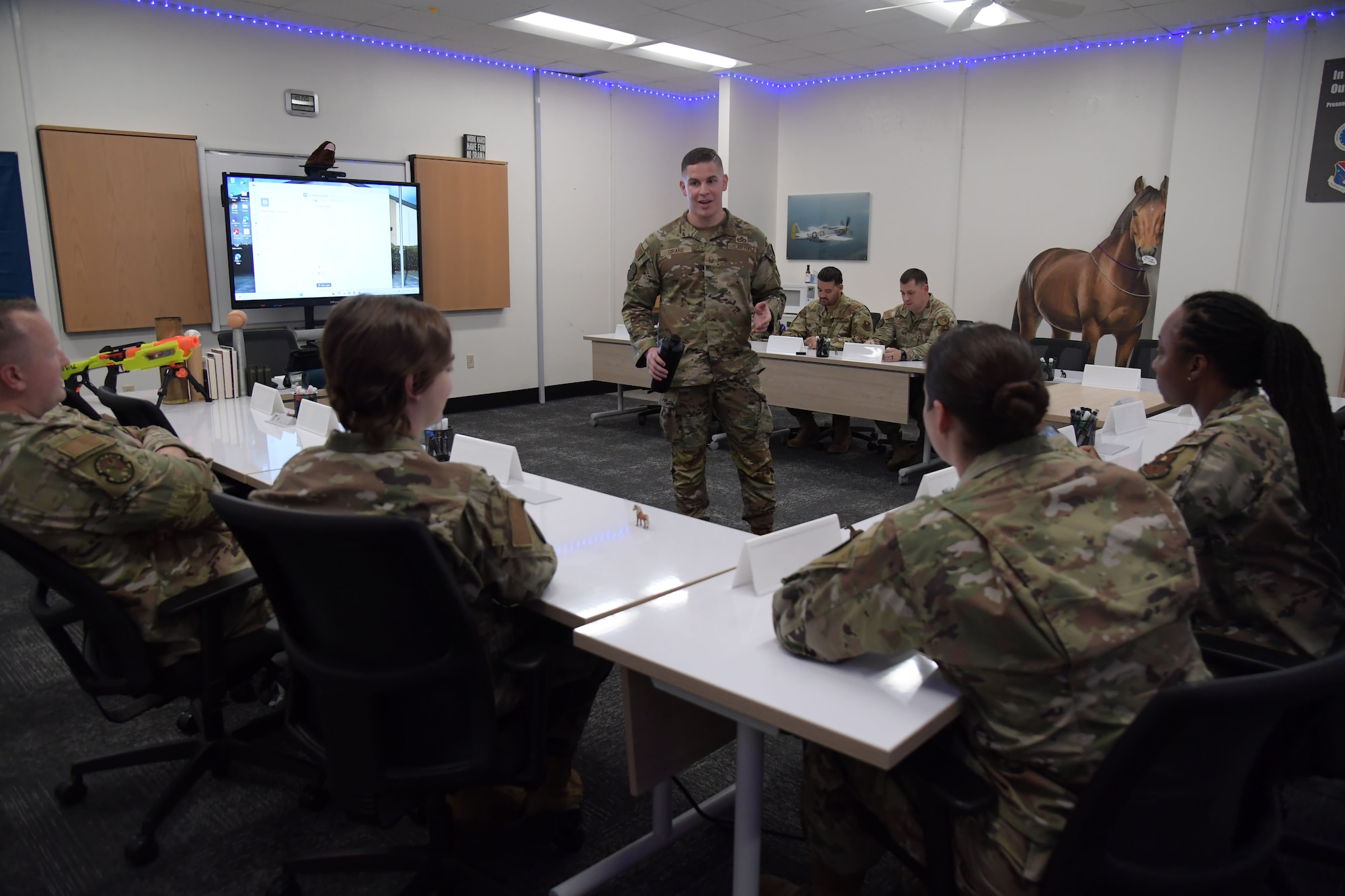 An Airman sitting at a desk.
