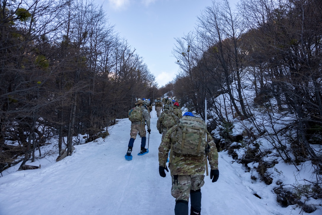 U.S. Marines with the Mountain Warfare Training Center and  8th Engineer Support Battalion, 2nd Marine Logistics Group and Argentine Marines, hike up a mountain during a cold weather exercise in Ushuaia, Argentina, Aug. 12, 2025. This training creates opportunities for continued combined exercises with Argentine forces which aim to build upon the skills learned in these knowledge exchanges. (U.S. Marine Corps photo by Lance Cpl. Payton Goodrich)