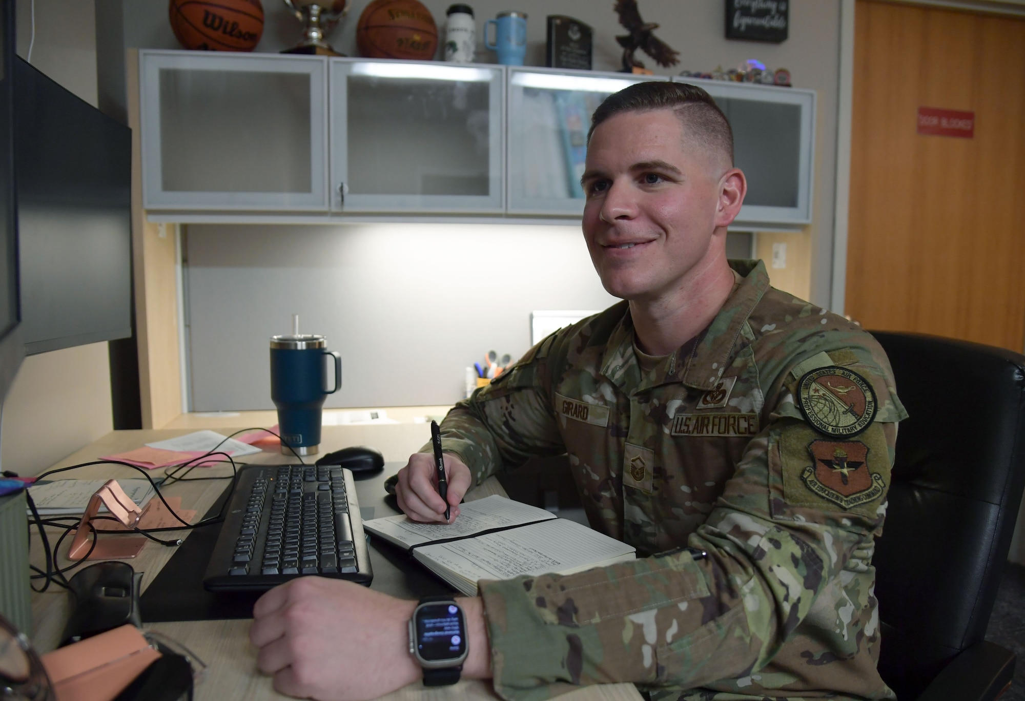 An Airman sitting at a desk.