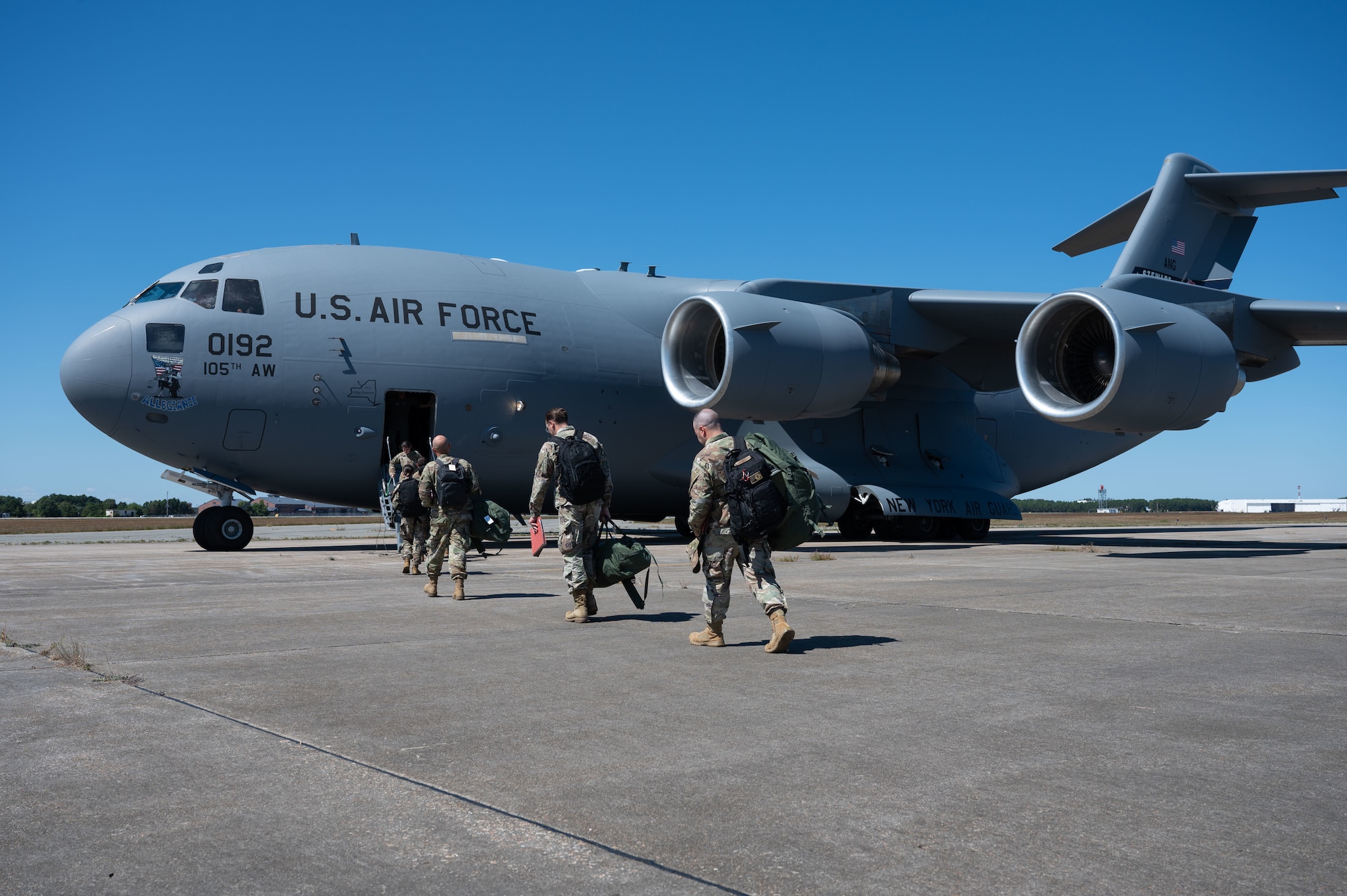 Airmen board an aircraft.