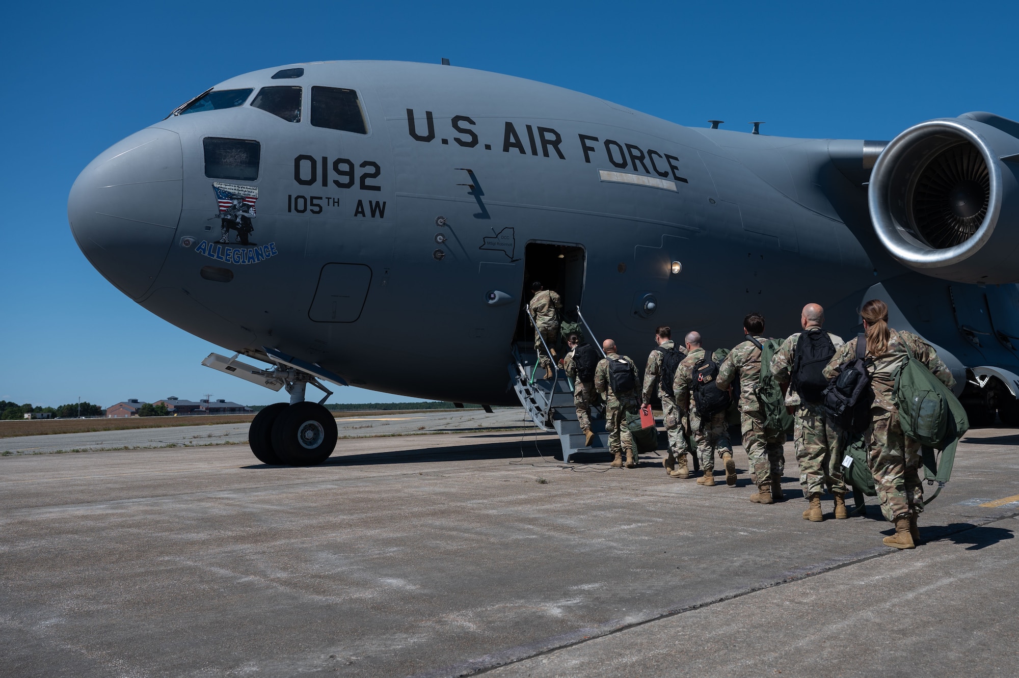 Airmen board an aircraft.