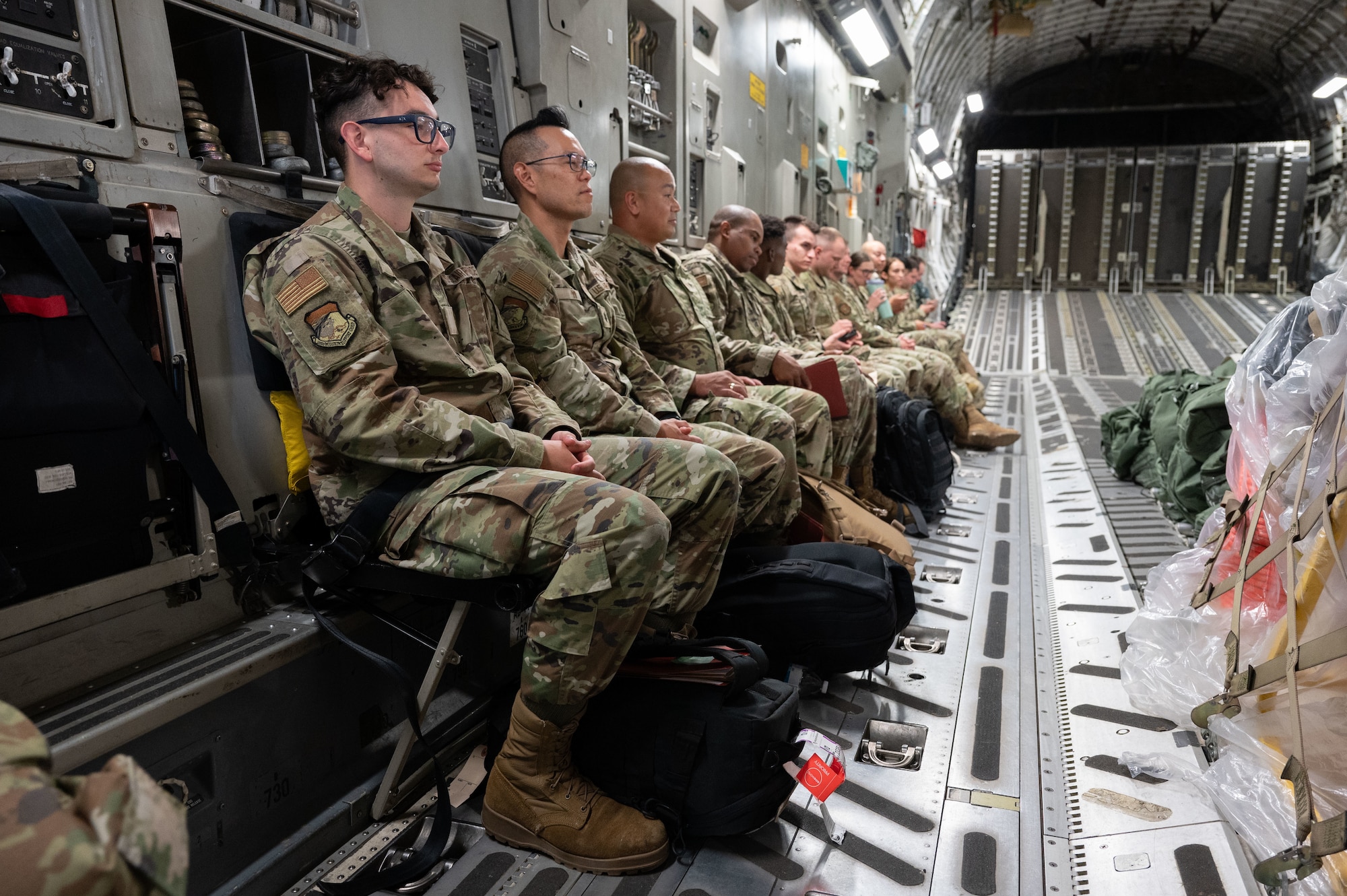 Airmen sit in aircraft.