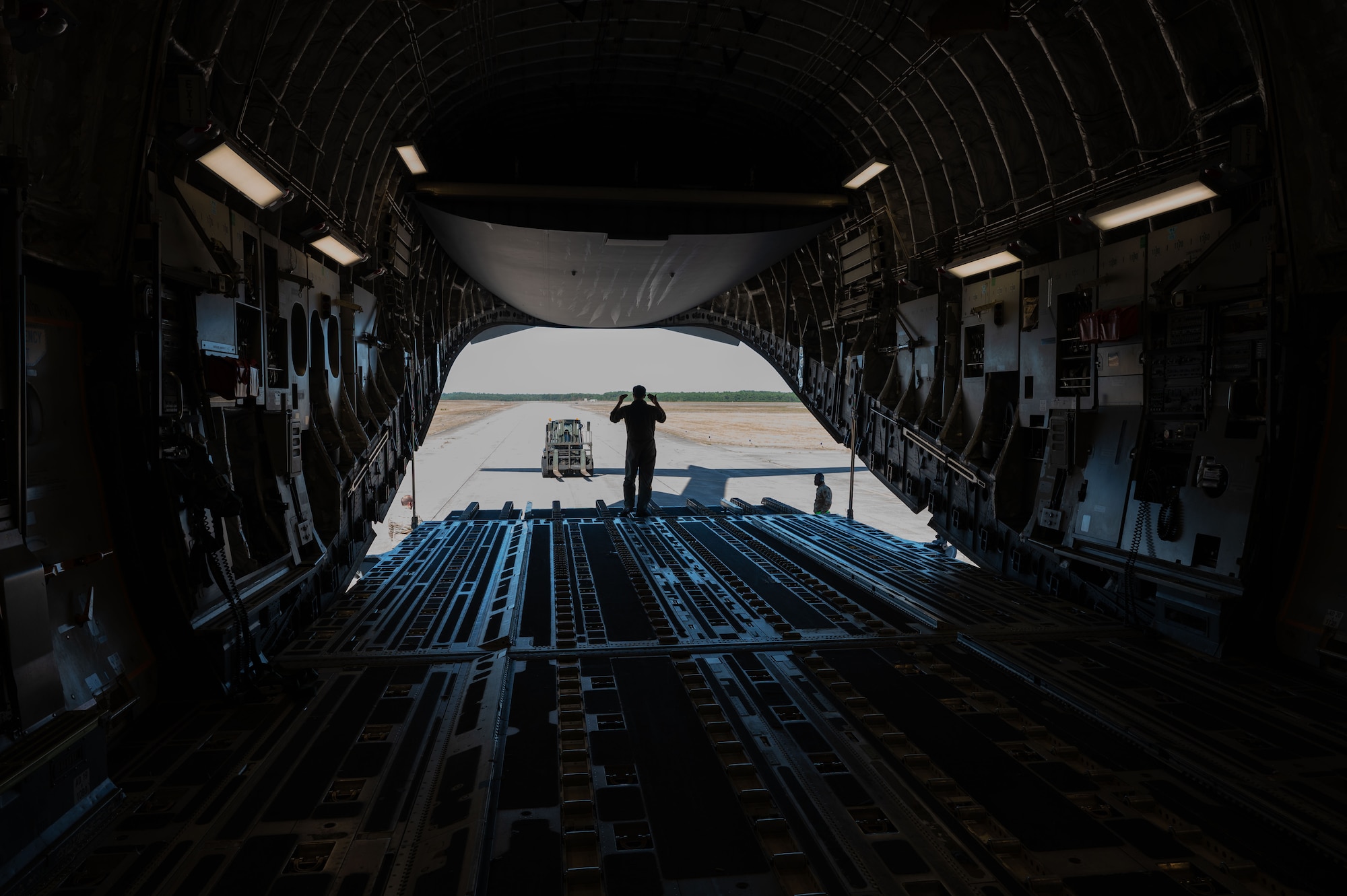 Airman loads cargo into aircraft.