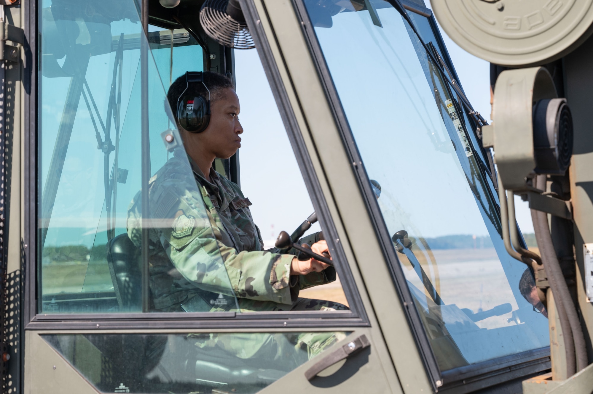 Airman drives forklift.