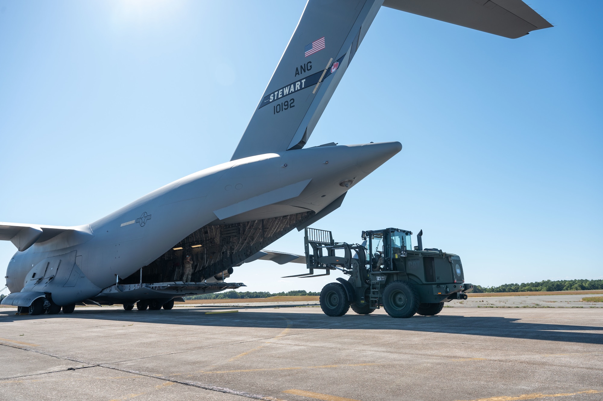 Airman loads cargo into aircraft.