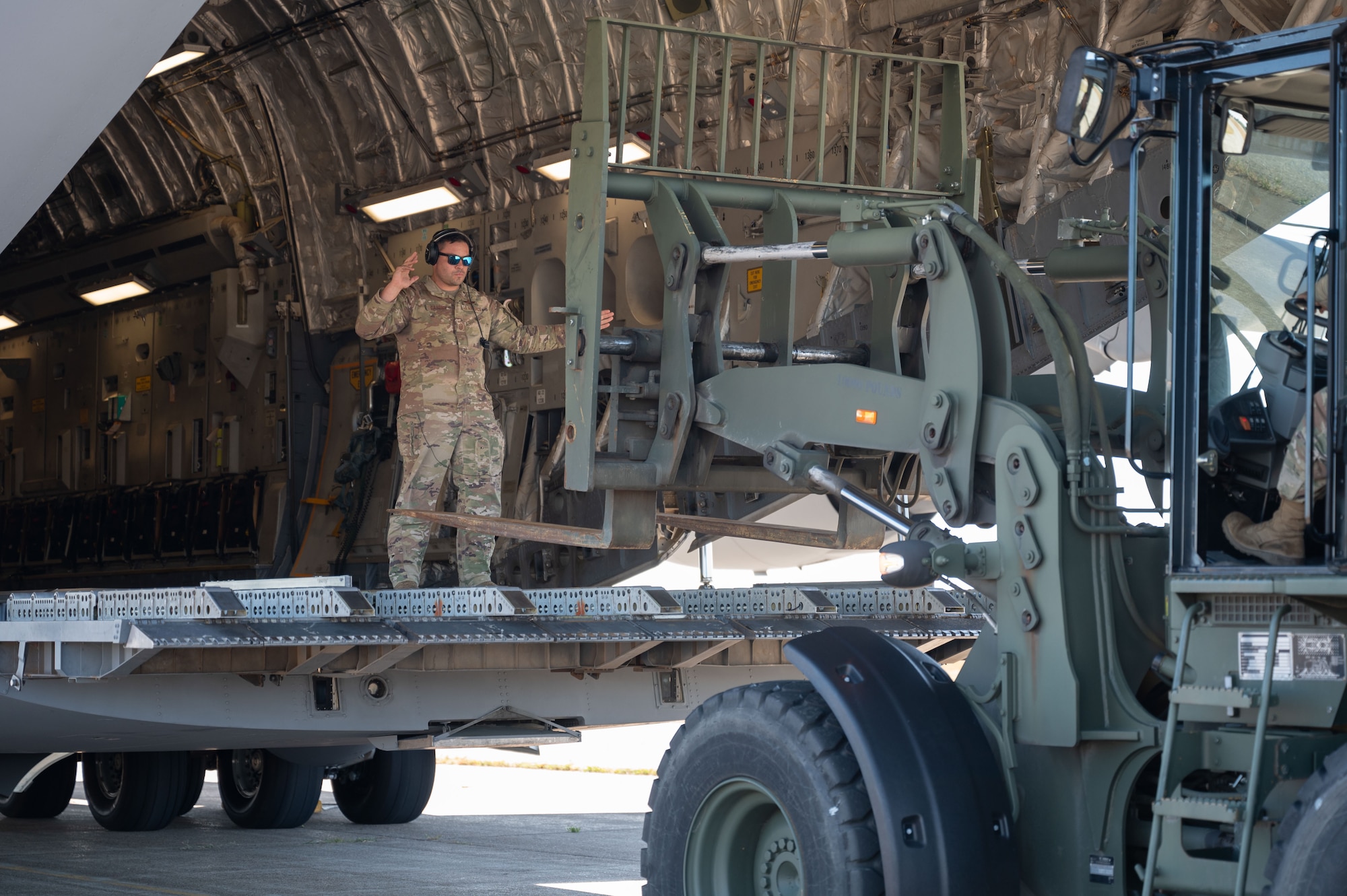Airman loads cargo into aircraft.