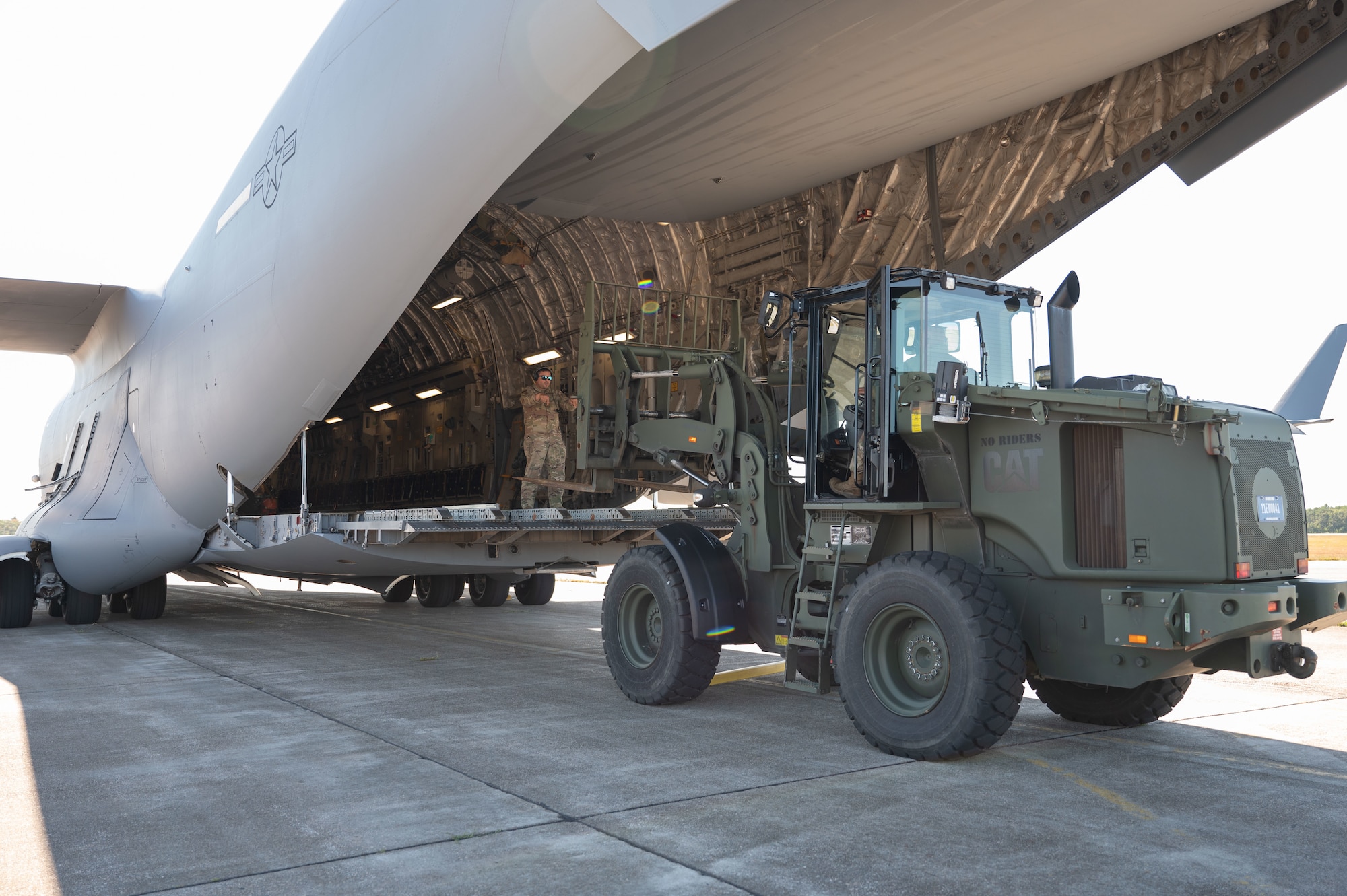 Airman loads cargo into aircraft.