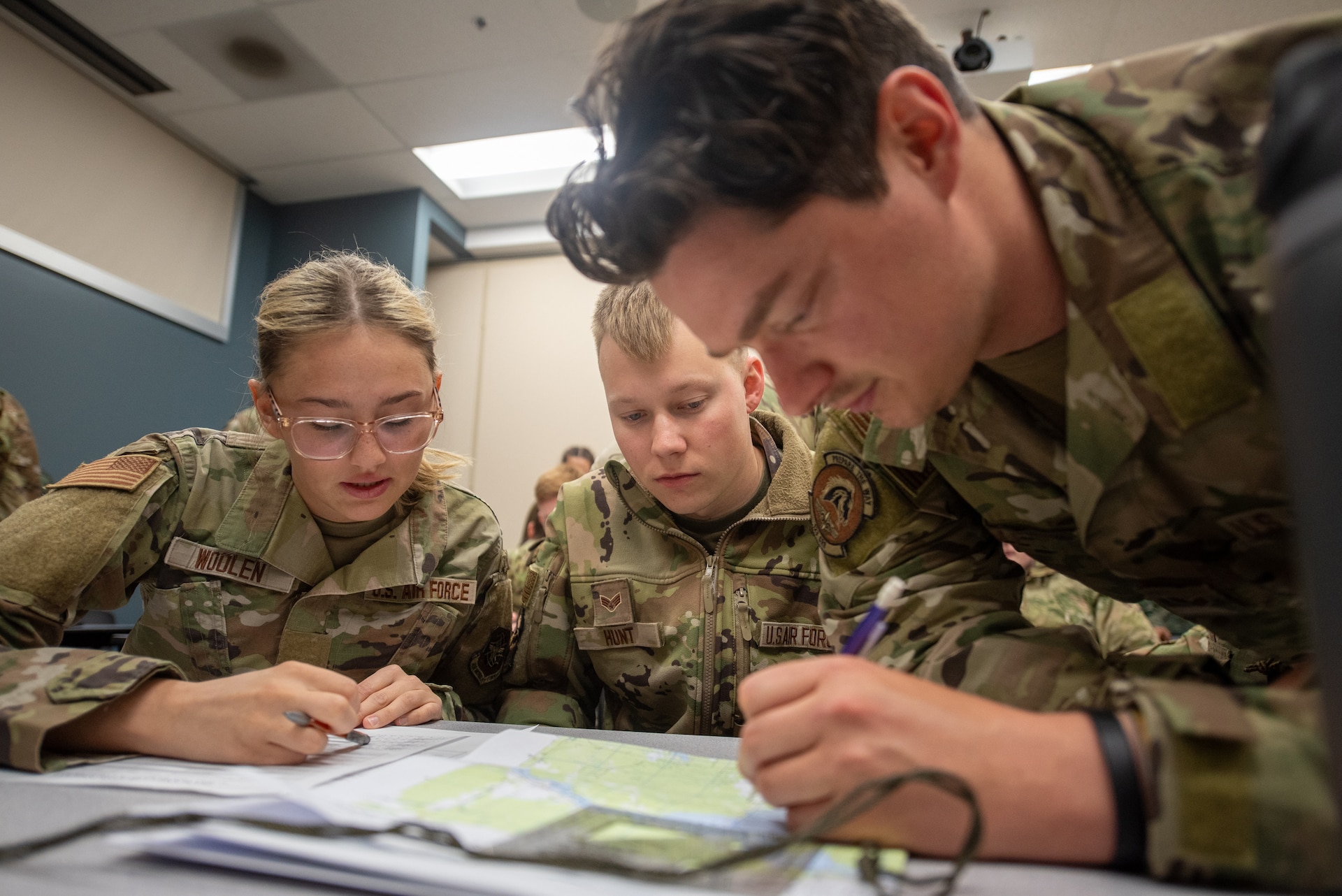 Airmen from the Kentucky Air National Guard’s 123rd Security Forces Squadron and 123rd Contingency Response Group plan routes prior to executing a land navigation course at the Alpena Combat Readiness Training Center in Alpena, Michigan, May 22, 2025.