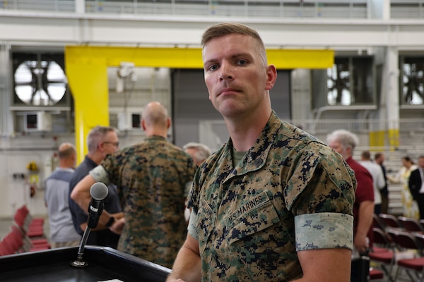 Gunnery Sgt. Jason M. Williams, career counselor with Marine Corps Logistics Command, speaks at Marine Corps Logistics Base Albany. Williams emphasizes that narrating goes beyond reading words—it's about representing the professionalism and standards of the Marine Corps.