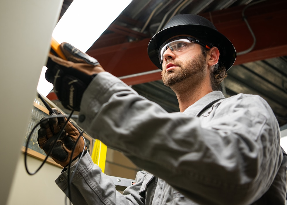 U.S. Air Force Tech. Sgt. Foster Grant, an electrical systems technician with the 446th Civil Engineer Squadron, tests voltage across fuses at Joint Base Lewis-McChord, Washington, on Aug. 20, 2025.