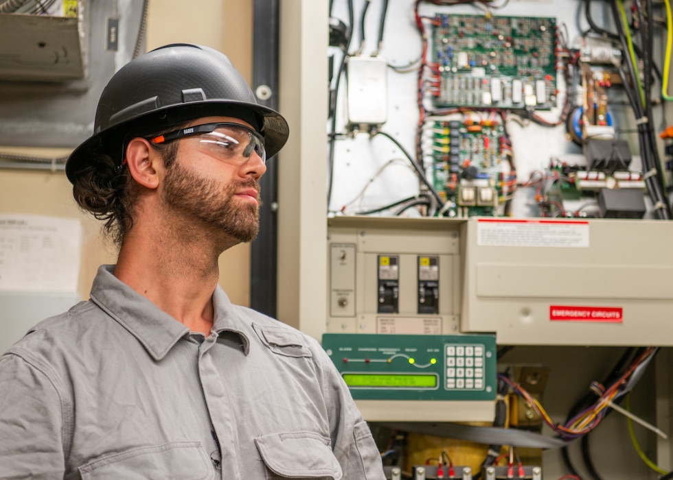 U.S. Air Force Tech. Sgt. Foster Grant, an electrical systems technician with the 446th Civil Engineer Squadron, inspects an electrical panel at Joint Base Lewis-McChord, Washington, on Aug. 20, 2025