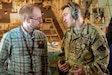 Staff Sgt. Tyler Phillips, a loadmaster from the Kentucky Air National Guard's 165th Airlift Squadron, explains his duties to a civilian employer during an orientation flight over Kentucky aboard a C-130J Super Hercules as part of a "Bosslift" held May 14, 2025.