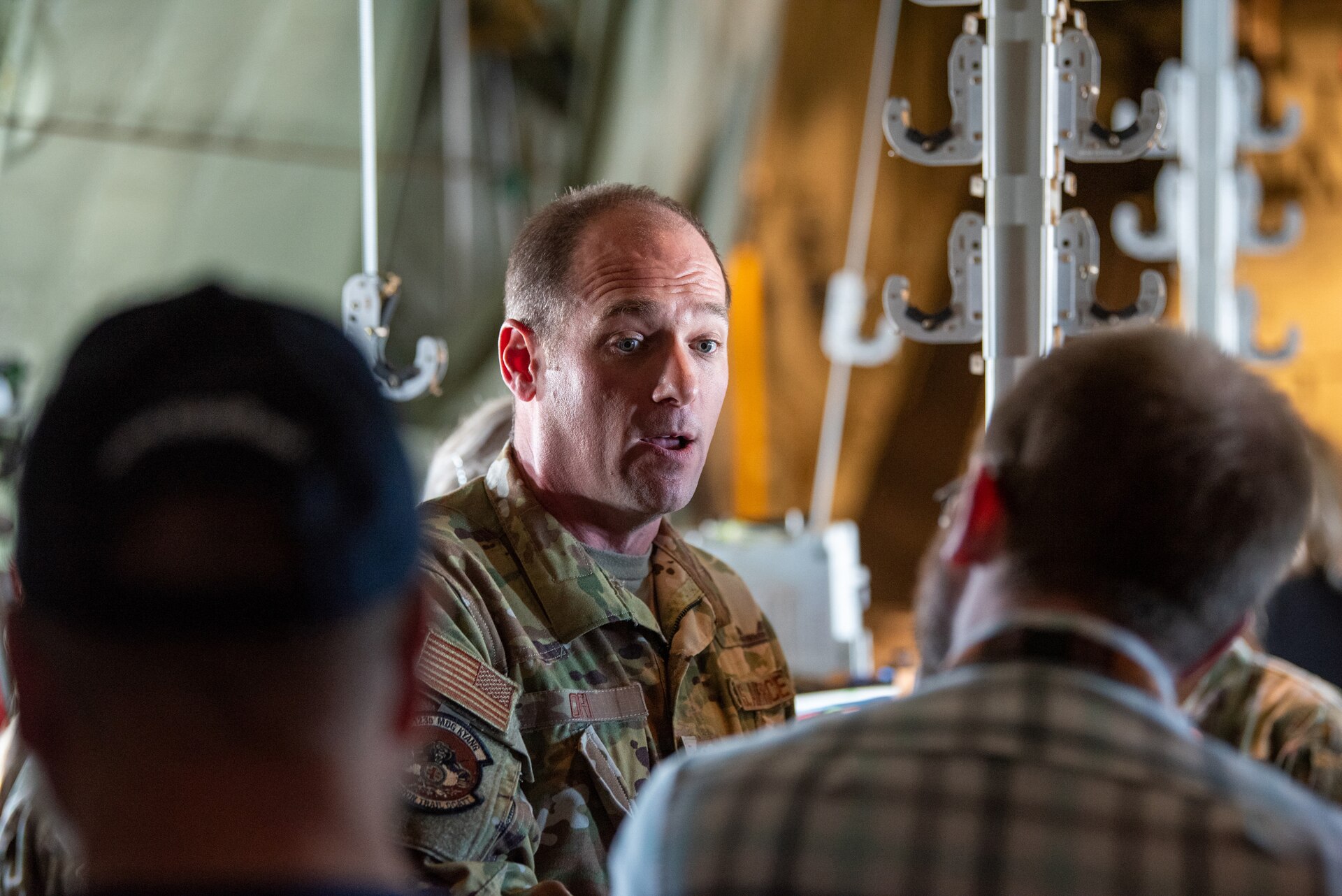 Lt. Col. Timothy Ori, a critical care physician from the 123rd Medical Group, talks to civilian employers about aeromedical evacuations aboard a Kentucky Air National Guard C-130J Super Hercules aircraft while in flight from Paducah, Kentucky, May 14, 2025, to support an earthquake-response exercise.