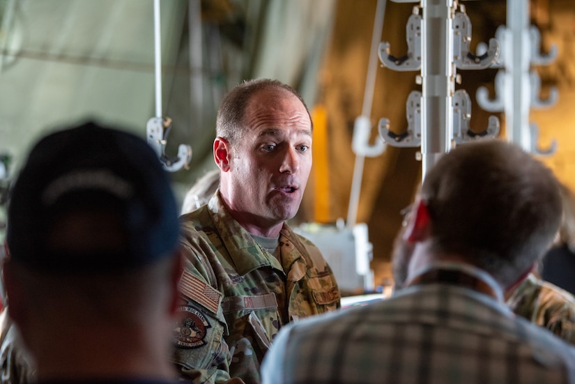 Lt. Col. Timothy Ori, a critical care physician from the 123rd Medical Group, talks to civilian employers about aeromedical evacuations aboard a Kentucky Air National Guard C-130J Super Hercules aircraft while in flight from Paducah, Kentucky, May 14, 2025, to support an earthquake-response exercise.