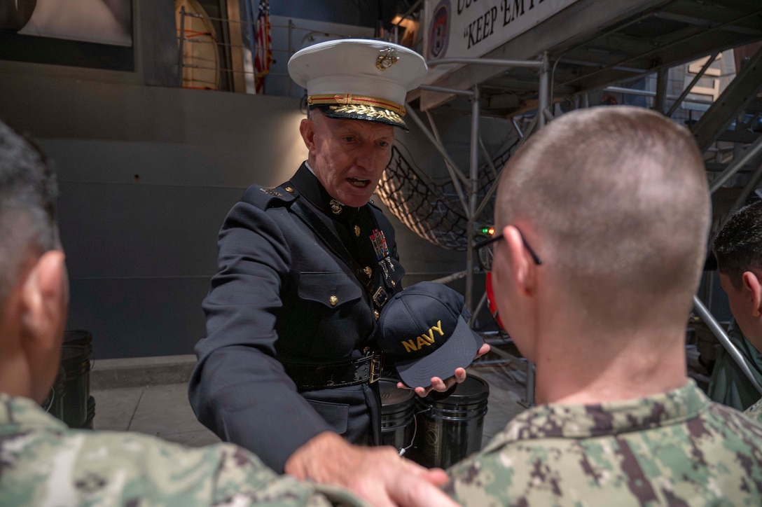 250821-N-MK109-1034 GREAT LAKES, Ill. (Aug. 21, 2025) Lt. Gen. William Bowers, commanding general, Marine Corps Recruiting Command, attends the capping ceremony on the pier of USS Trayer at Recruit Training Command (RTC). Trayer, more commonly referred to as "Battle Stations," is the crucible event that recruits must pass prior to graduation, testing their knowledge and skills in basic seamanship, damage control, firefighting and emergency response procedures. Training at RTC is approximately nine weeks, and all enlistees in the U.S. Navy begin their careers at the command. More than 40,000 recruits train annually at the Navy's only boot camp. (U.S. Navy photo by Mass Communication Specialist 2nd Class Mykala Keckeisen)