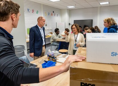STAFFORD, Va. – Naval Surface Warfare Center Dahlgren Division (NSWCDD) Technology Officer (acting) Parker Page (second from left) speaks with Academy of Technology and Innovation at the University of Mary Washington teacher Judy Munoz-Lollar about the school’s makerspace. NSWCDD donated 3D printers, a resin printer and 3D scanner materials to support the program’s students. (Dave Ellis/NSWCDD Photo)