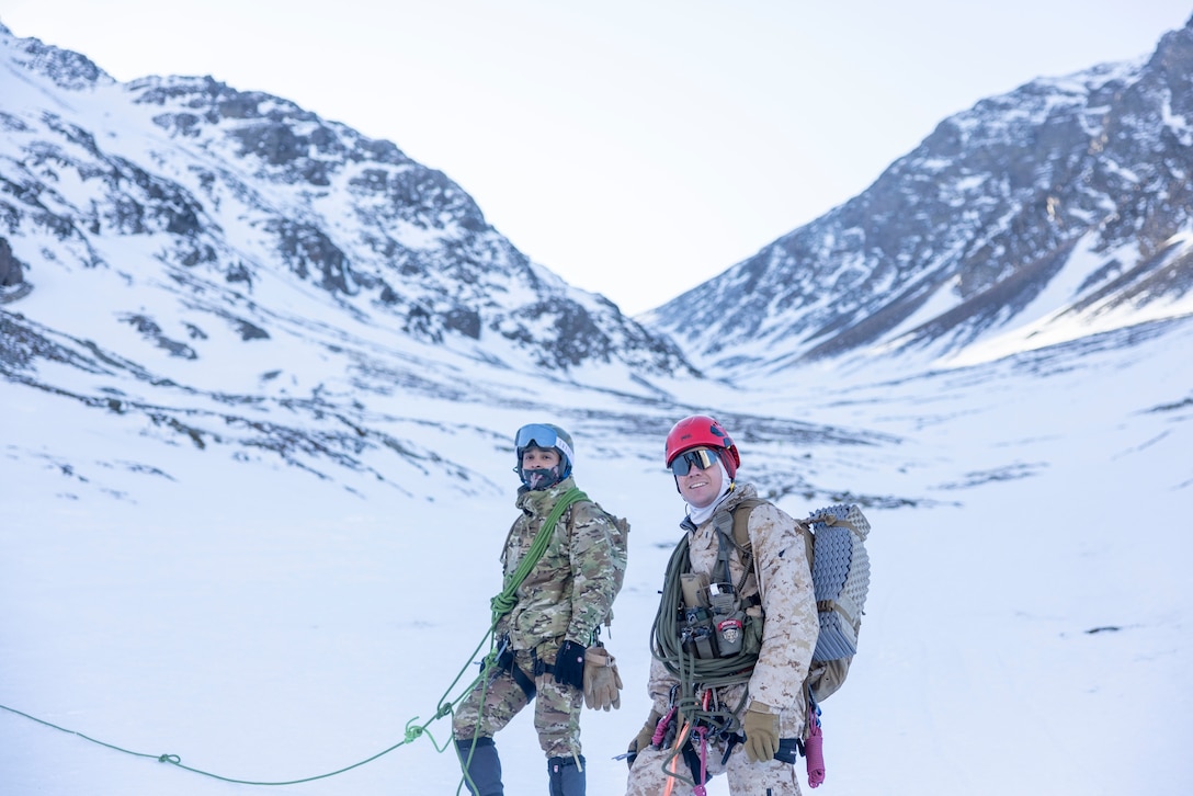 U.S. Marine Corps 1st Lt. Damon Crossland, with the Mountain Warfare Training Center, and Midshipman of Infantry Marines. (2nd Lt.) Isaias Diaz, a member of the Batallón de Infantería de Marina 5, pause to check on the U.S. and Argentinean Marines during a hike up a mountain, in Ushuaia, Argentina, Aug 13, 2025. This training creates opportunities for continued combined exercises with Argentine forces which aims to build upon the skills learned in these knowledge exchanges. (U.S. Marine Corps photo by Lance Cpl. Payton Goodrich)