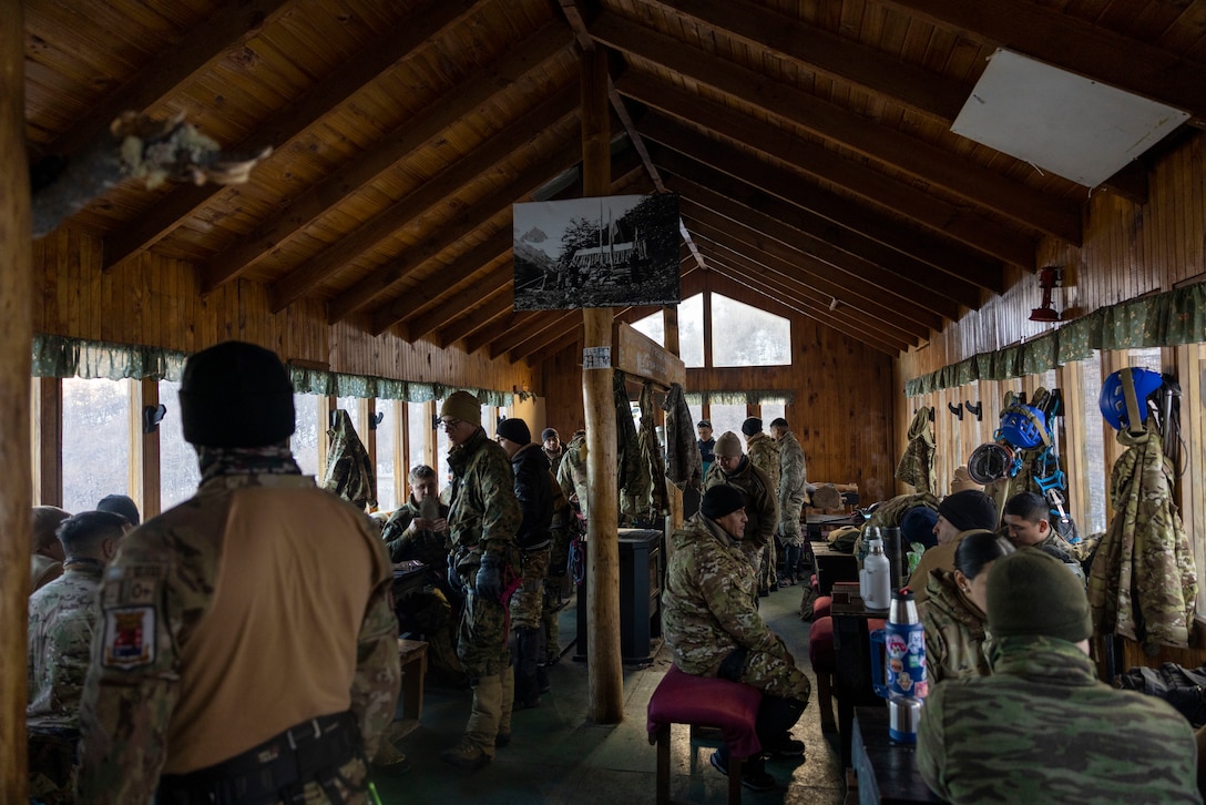 U.S. Marines from the Mountain Warfare Training Center and 8th Engineering Support Battalion, 2nd Marine Logistics Group, have lunch and share Mata, a type of tea, with Argentinian marines from Batallón de Infantería de Marina 4 and 5, during a cold weather exercise in Ushuaia, Argentina, Aug 13, 2025. This training creates opportunities for continued combined exercises with Argentine forces which aims to build upon the skills learned in these knowledge exchanges. (U.S. Marine Corps photo by Lance Cpl. Payton Goodrich)