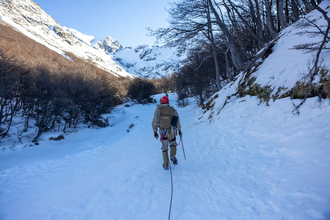 U.S. Marine Corps 1st Lt. Damon Crossland, with the Mountain Warfare Training Center, hikes up a mountain during a cold weather exercise in Ushuaia, Argentina, Aug. 13, 2025. This training creates opportunities for continued combined exercises with Argentine forces which aims to build upon the skills learned in these knowledge exchanges. (U.S. Marine Corps photo by Lance Cpl. Payton Goodrich)