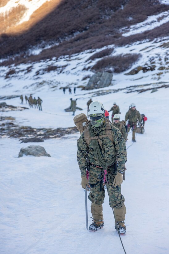 U.S. Marine Corps Cpl. Angel Reyes, a member of the 8th Engineering Support Battalion, 2nd Marine Logistics Group, hikes up a mountain during a cold weather exercise in Ushuaia, Argentina, Aug. 13, 2025. This training creates opportunities for continued combined exercises with Argentine forces which aims to build upon the skills learned in these knowledge exchanges. (U.S. Marine Corps photo by Lance Cpl. Payton Goodrich)