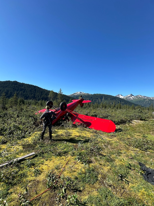 A Coast Guard MH-60 Jayhawk helicopter aircrew from Coast Guard Air Station Sitka rescues a man from a downed aircraft near Haines, Alaska, Aug. 24, 2025. The pilot was the only person aboard the  aircraft and had no reported injuries. (U.S. Coast Guard photo courtesy of Air Station Sitka)