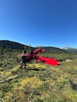 A Coast Guard MH-60 Jayhawk helicopter aircrew from Coast Guard Air Station Sitka rescues a man from a downed aircraft near Haines, Alaska, Aug. 24, 2025. The pilot was the only person aboard the  aircraft and had no reported injuries. (U.S. Coast Guard photo courtesy of Air Station Sitka)