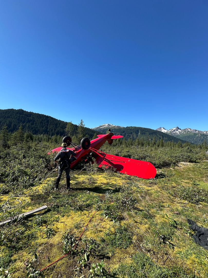 A Coast Guard MH-60 Jayhawk helicopter aircrew from Coast Guard Air Station Sitka rescues a man from a downed aircraft near Haines, Alaska, Aug. 24, 2025. The pilot was the only person aboard the  aircraft and had no reported injuries. (U.S. Coast Guard photo courtesy of Air Station Sitka)