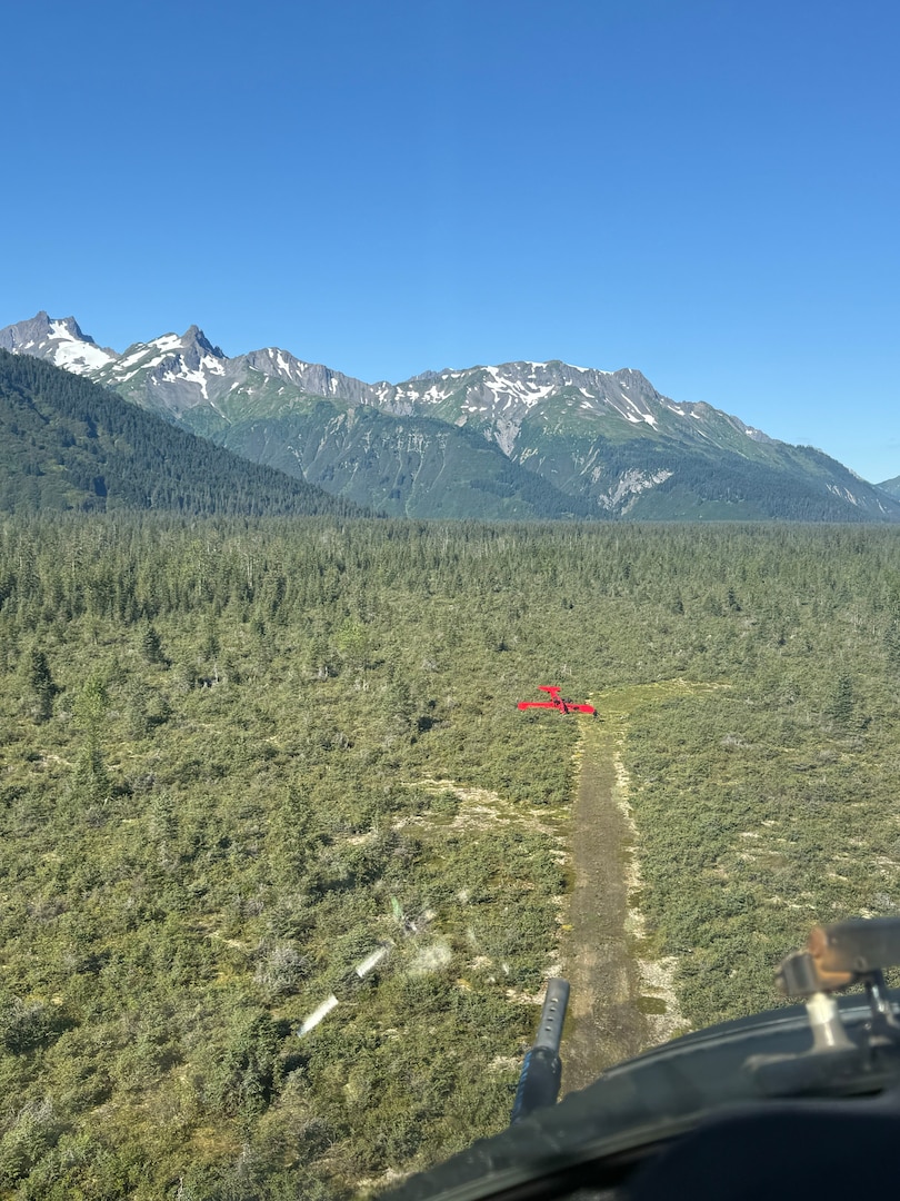 A Coast Guard MH-60 Jayhawk helicopter aircrew from Coast Guard Air Station Sitka rescues a man from a downed aircraft near Haines, Alaska, Aug. 24, 2025. The pilot was the only person aboard the  aircraft and had no reported injuries. (U.S. Coast Guard photo courtesy of Air Station Sitka)