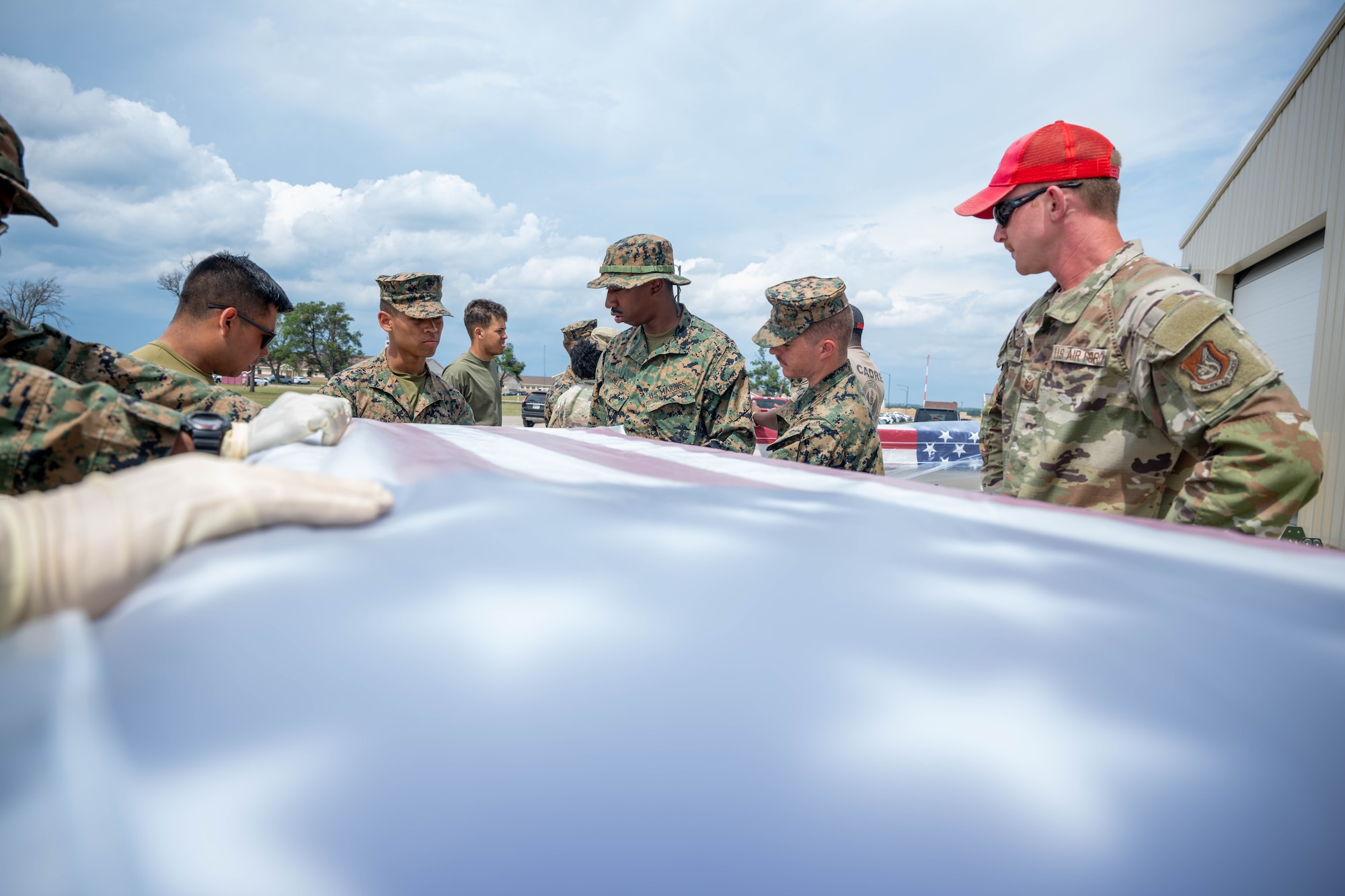 U.S. Air Force Tech. Sgt. Preston Wade, 554th REDHORSE non-commissioned officer in charge of contingency training, teaches participating members of the Air Force Mortuary Affairs Operations expeditionary mortuary how to open a transfer case during re-icing at Grayling Army Airfield, Michigan, Aug. 11, 2025. The expeditionary mortuary was a part of Northern Strike 25-2, an annual exercise in Michigan. (U.S. Air Force photo by Senior Airman Madeline Baisey)