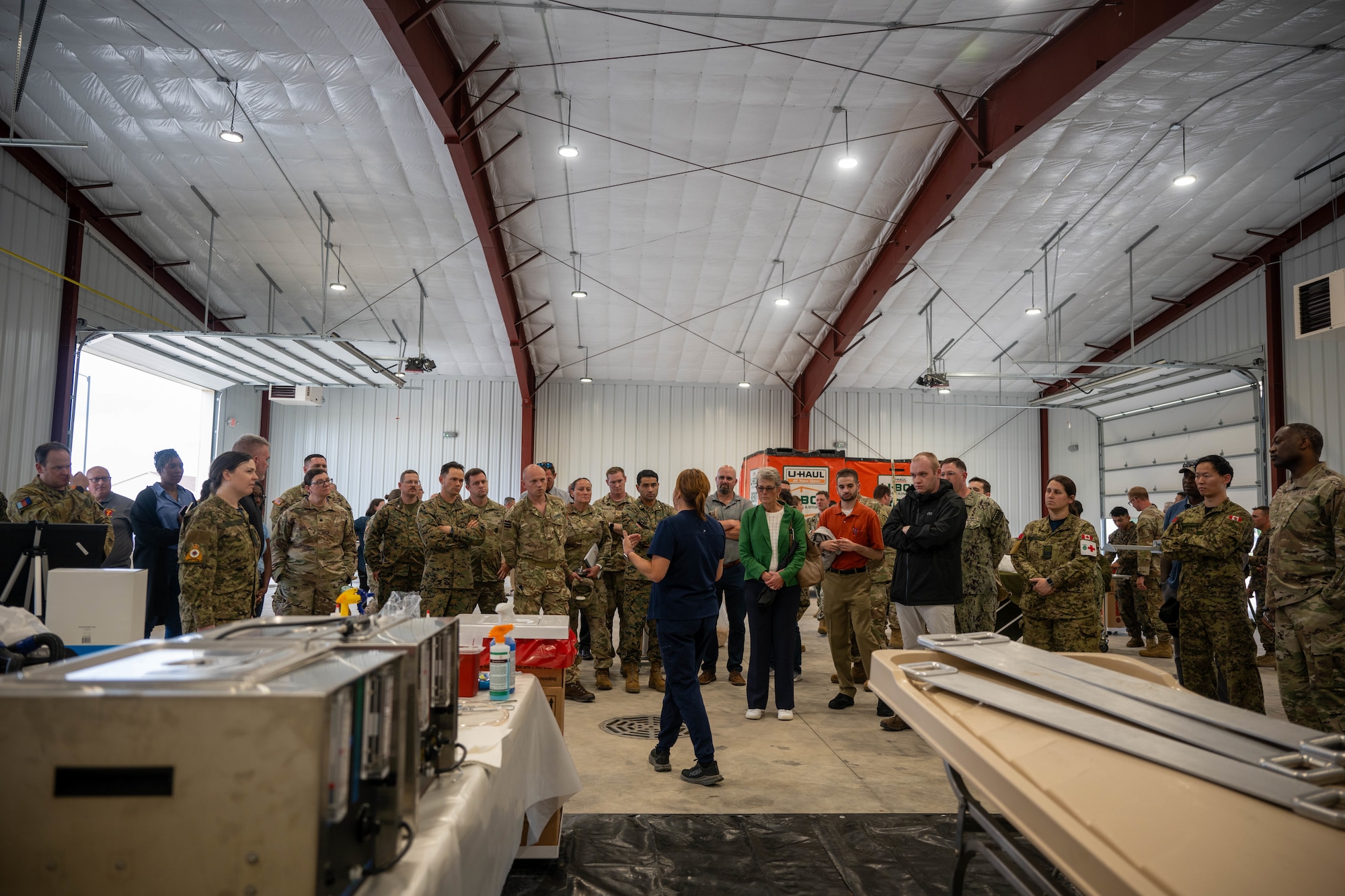 Danielle Wilk, Air Force Mortuary Affairs Operations port mortuary branch chief, explains the embalming procedures done within the AFMAO expeditionary mortuary at Grayling Army Airfield, Michigan, Aug. 12, 2025. Wilk and other participating AFMAO members participated as instructors and embalmers during exercise Northern Strike 25-2. (U.S. Air Force photo by Senior Airman Madeline Baisey)