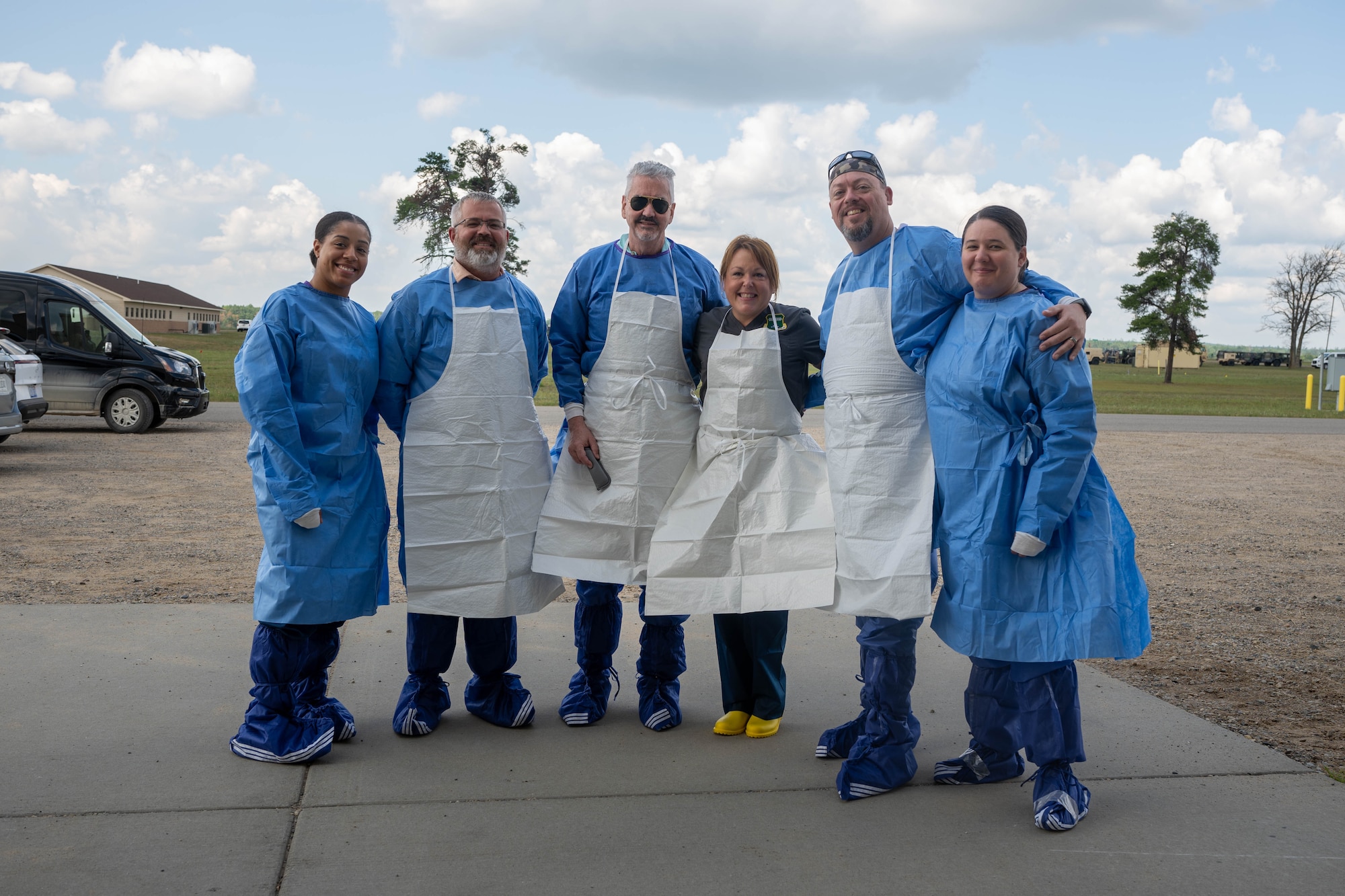 The expeditionary mortuary team of embalmers pose for a photo at Grayling Army Airfield, Michigan, Aug. 13, 2025. The team successfully practiced expediting the embalming procedures done in a contested environment during the annual exercise Northern Strike. (U.S. Air Force photo by Senior Airman Madeline Baisey)