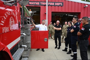 Chris Wysong, chief of Wayne Township Fire Deptartment, gives a tour Aug. 22 to a delegation of four firefighters from the Serbian Volunteer Fire Department. The delegation spent time with both professional and volunteer fire departments to observe operations, share best practices, and foster international relationships. (U.S. Air National Guard photo by Shane Hughes)
