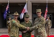 U.S. Army Soldiers from U.S. Army Pacific (USARPAC), 1st (Australian) Division Soldiers, and the Japan Ground Self-Defense Force (JGSDF) members salute their national colors during the opening ceremony of Exercise Yama Sakura 89 on JGSDF Camp Itami, Japan, Aug. 25, 2025.