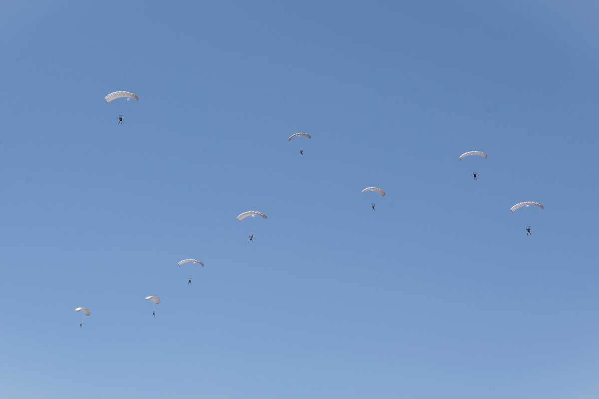 Pararescuemen parachute down to earth