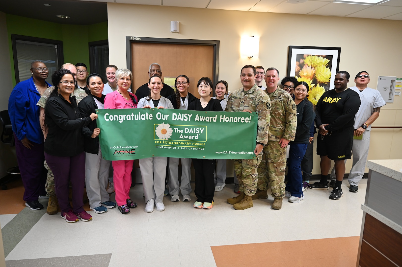 Registered Nurse Susan Kaurudar takes a photo with her team after receiving the CRDAMC inpatient DAISY award.