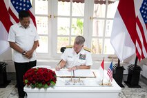 Adm. Samuel J. Paparo, commander of U.S. Indo-Pacific Command, signs a guest book prior to meeting with Indonesian Deputy Minister of Defense retired Air Marshal Donny Ermawan at the Ministry of Defense in Jakarta, Indonesia, Aug. 24, 2025.