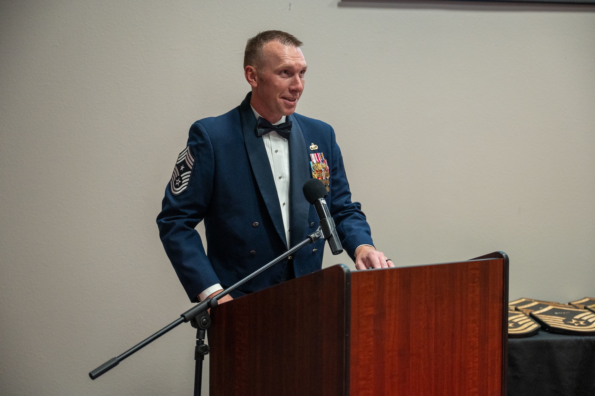 U.S. Air Force Chief Master Sgt. Derek Neill, 17th Training Wing command chief, speaks at the Senior Noncommissioned Officer Induction Ceremony at the Powell Event Center, Goodfellow Air Force Base, Texas, Aug. 22, 2025. The ceremony is a traditional rite of passage that welcomes newly promoted master sergeants and other SNCO selectees into the highest echelon of the enlisted force. (U.S. Air Force photo by Airman 1st Class James Salellas)