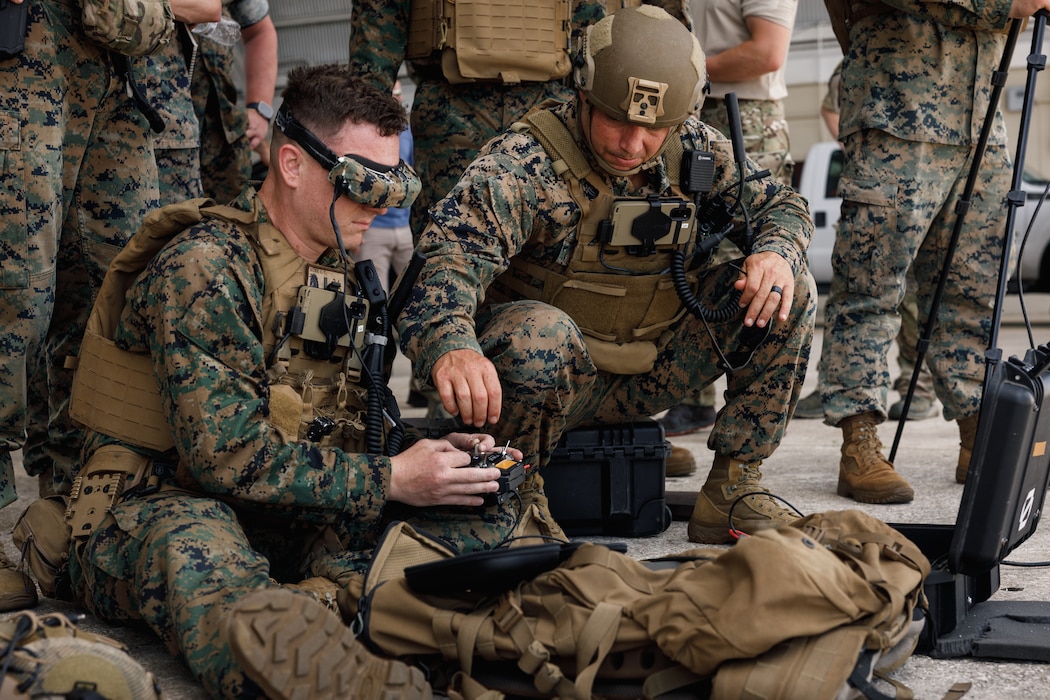 U.S. Marine Corps 1st Lt. Lucas Scher, an infantry officer and group one small Unmanned Aerial System operator, left, and Gunnery Sgt. Seth Utsler, an assaultman, scout sniper instructor, and team chief, both with the Marine Corps Attack Drone Team, conduct group one sUAS tactical flight operations during an sUAS joint interoperability training exercise at an undisclosed location within the U.S. Northern Command area of responsibility