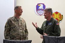 U.S. Air Force Gen. Gregory Guillot (left), Commander, U.S. Northern Command and North American Aerospace Defense Command, and U.S. Navy Adm. Samuel Paparo (right), Commander, U.S. Indo-Pacific Command, speak together while visiting Fort Greely, Alaska, Aug. 19, 2025, during exercise Northern Edge 2025. NE25 is an exercise led by U.S. Indo-Pacific Command that serves as a platform for joint, multi-domain operations to deliver high-end, realistic warfighter training, strengthen joint interoperability, and sharpen the air and sea-based combat readiness of U.S. and participating forces. (U.S. Air Force photo by Airman 1st Class Spencer Hanson)