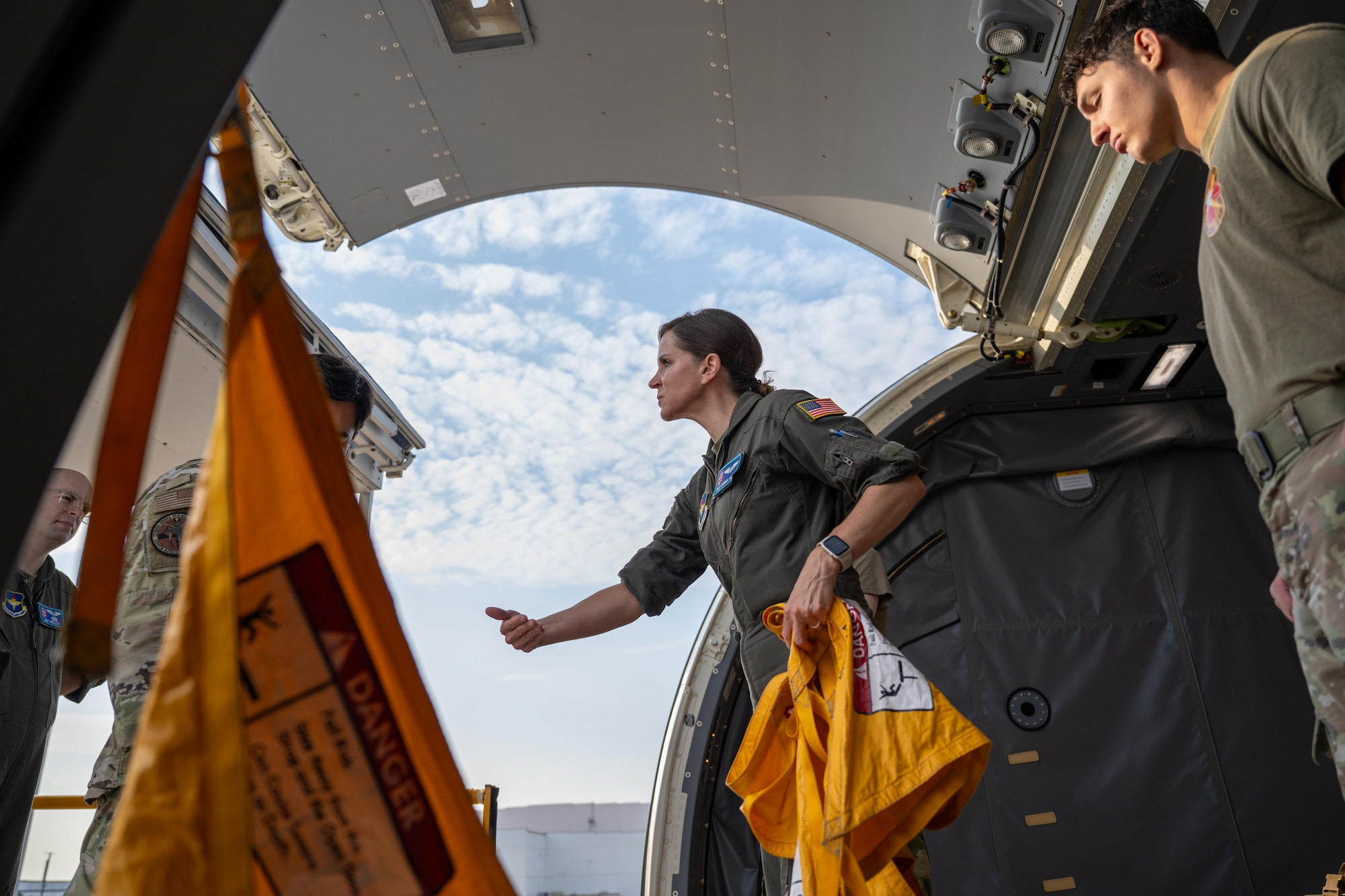 U.S. Air Force Staff Sgt. Danika Vance, 56th Air Refueling Squadron instructor boom operator, leads the loading of a KC-46 Pegasus aircraft at Kelly Field, San Antonio, Texas, Aug. 21, 2025. The aircraft was being loaded with medical equipment and personnel to conduct the “Vapor Trails” exercise, an exercise usually performed on larger cargo aircraft. (U.S. Air Force photo by Airman 1st Class Lauren Torres)