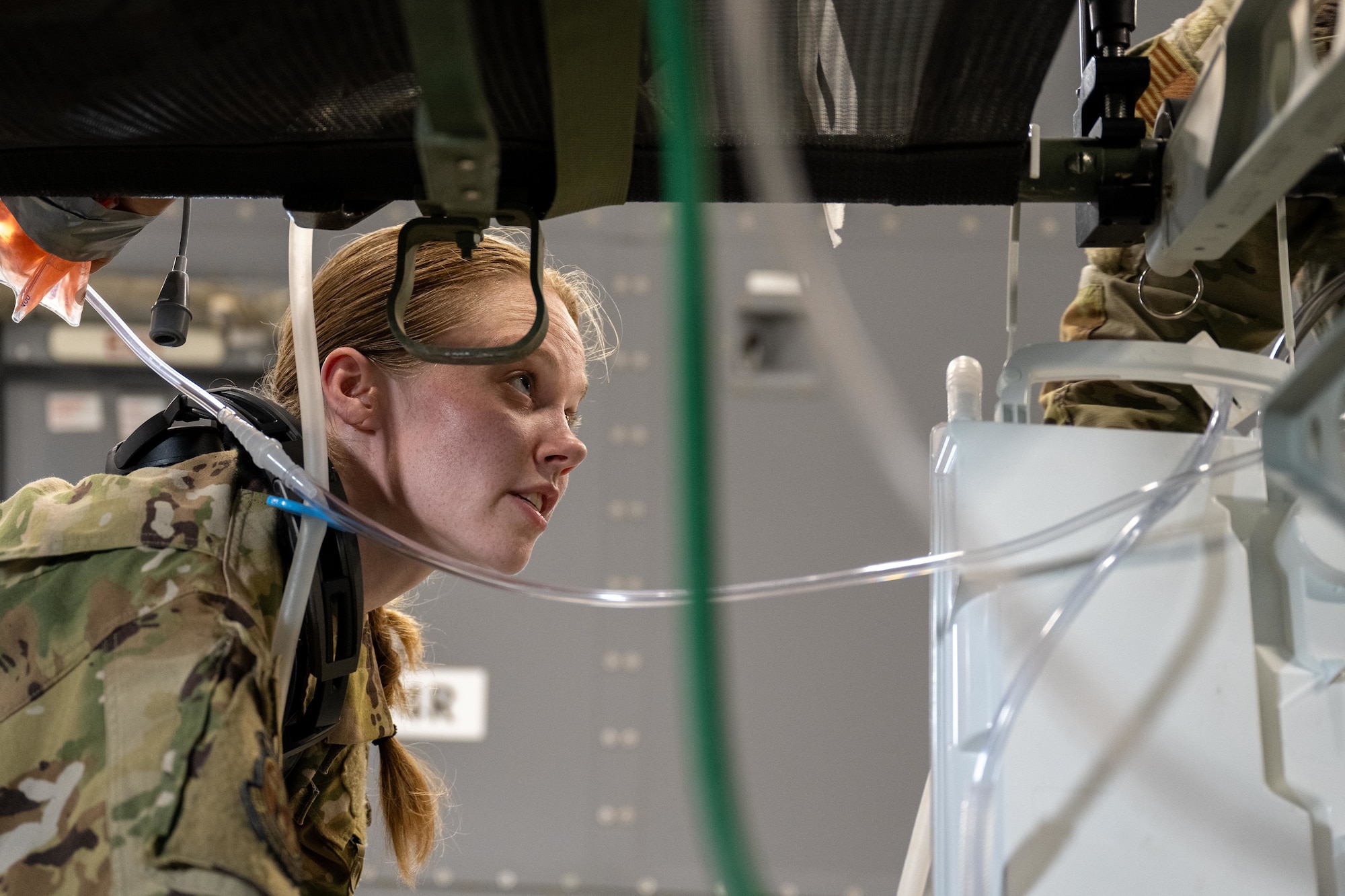 U.S. Air Force Staff Sgt. Nicole Small, Tinker Air Force Base 137th Aeromedical Evacuation Squadron aeromedical evacuation technician, sets up in-flight medical equipment on a KC-46 Pegasus aircraft at Kelly Airfield, San Antonio, Texas, Aug. 21, 2025. The equipment was prepared to support simulated patient care, allowing medical teams to train alongside aircrew during the “Vapor Trails” exercise. (U.S. Air Force photo by Airman 1st Class Lauren Torres)
