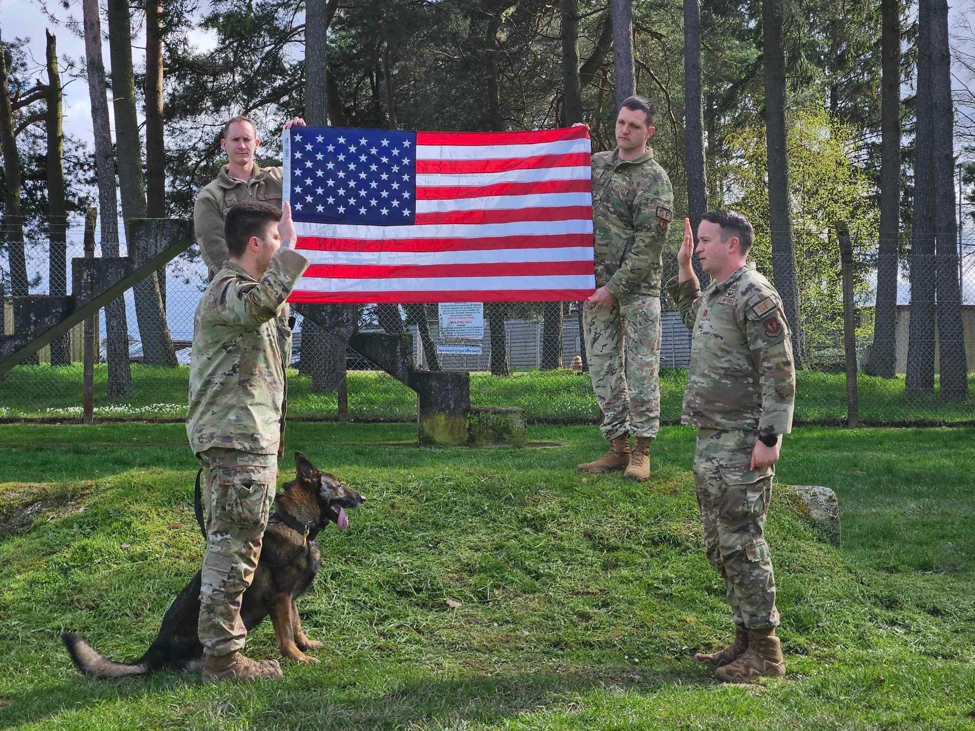 a man salutes another man with a dog sitting next to him
